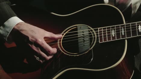 Jazz-guitarist-plays-a-black-guitar-in-a-melancholic-way