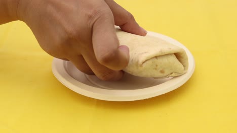 Detail-shot-of-chicken-warp-on-wooden-table