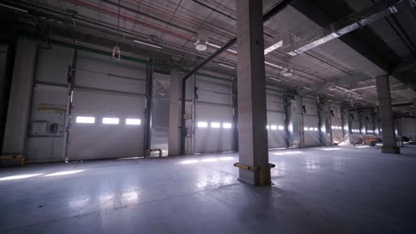 construction process of a big, modern warehouse with multiple garage gates for easy access and transportation of goods.