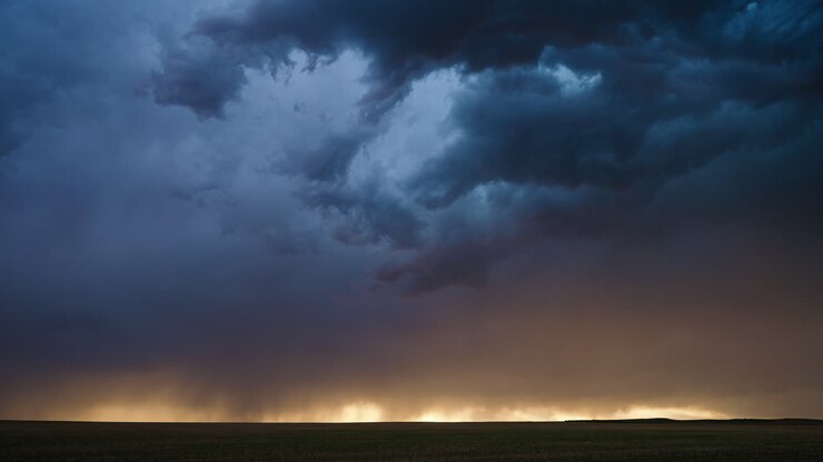 Dramatic sky with lightning bolts cutting through thick clouds over hills