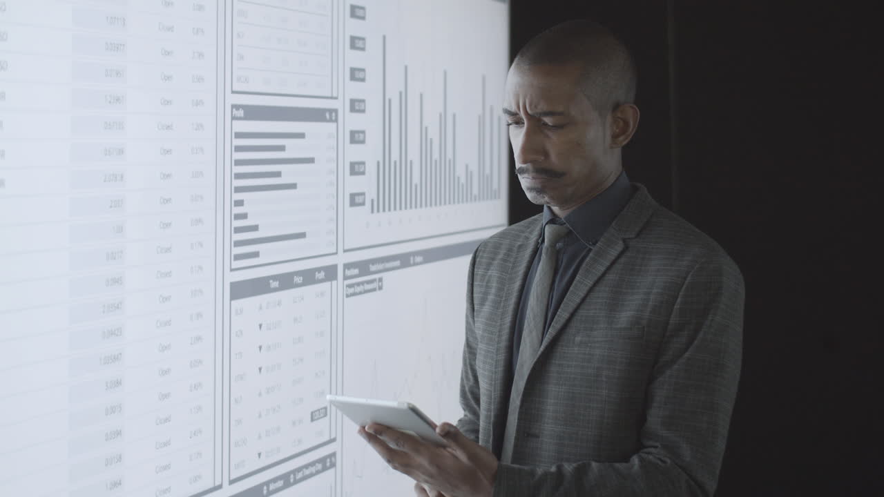 Pensive African American investor analyzing charts