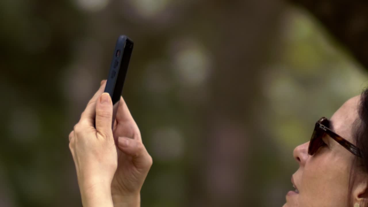 She navigates her phone with ease, a blend of grace and tech