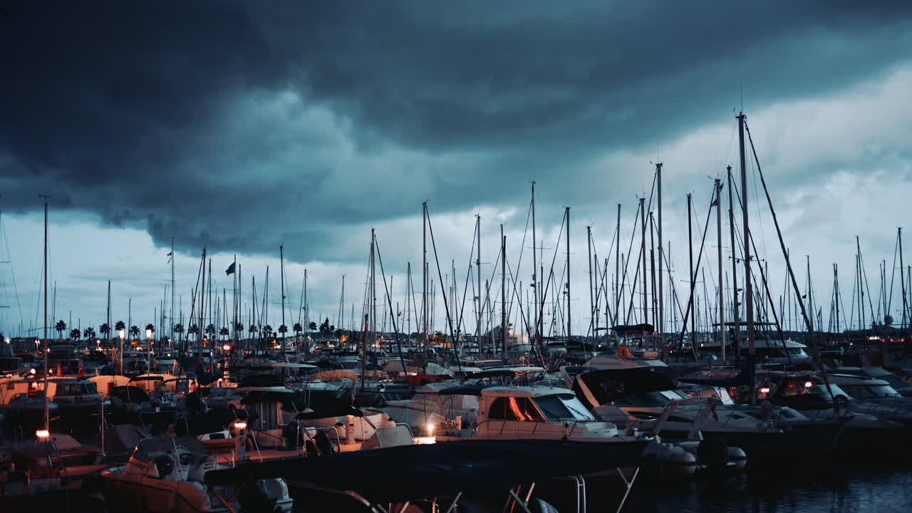 Cannes, France - November 20, 2025: A evening view of a marina under dark, moody storm clouds