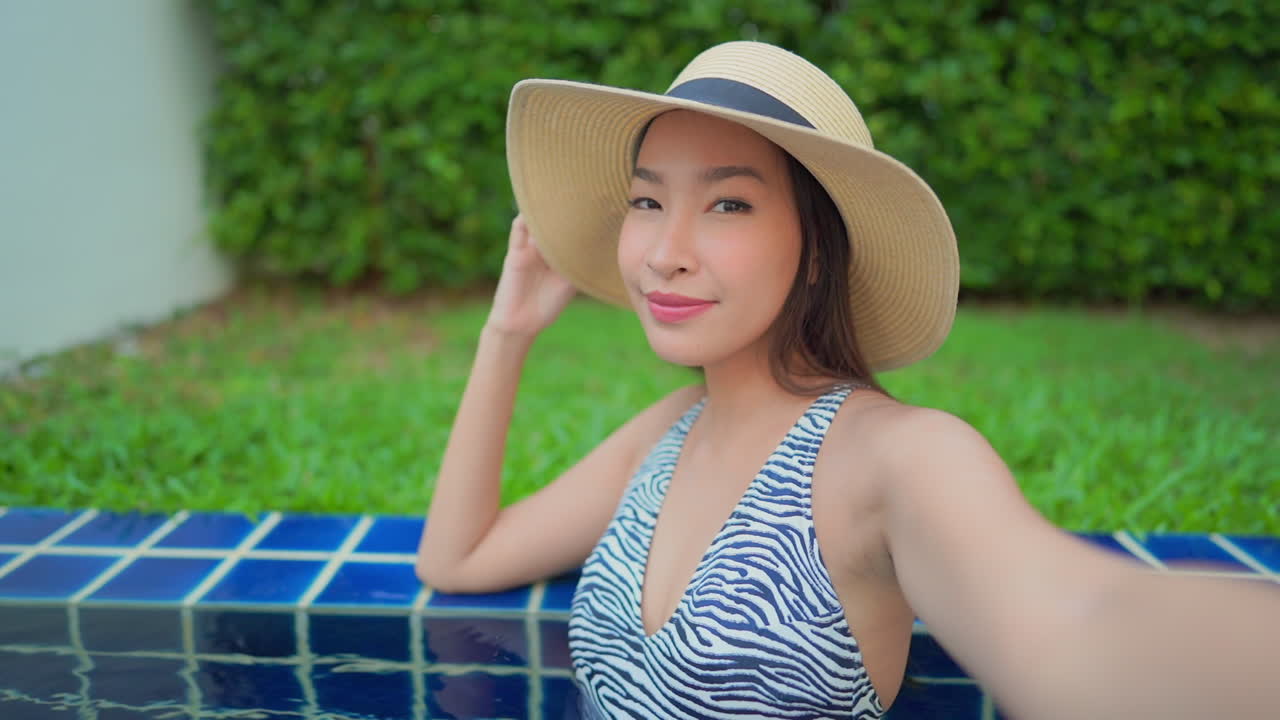 Close-up, young, Asian woman choosing her angle for a selfie
