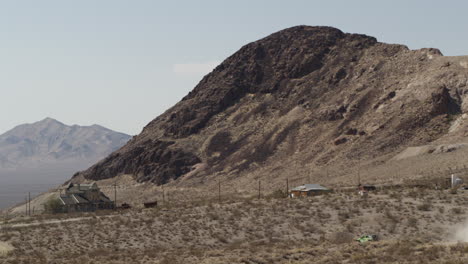 mining town of rhyolite, nevada against the desert landscape, wide