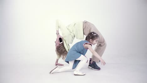 mother and daughter performing yoga pose