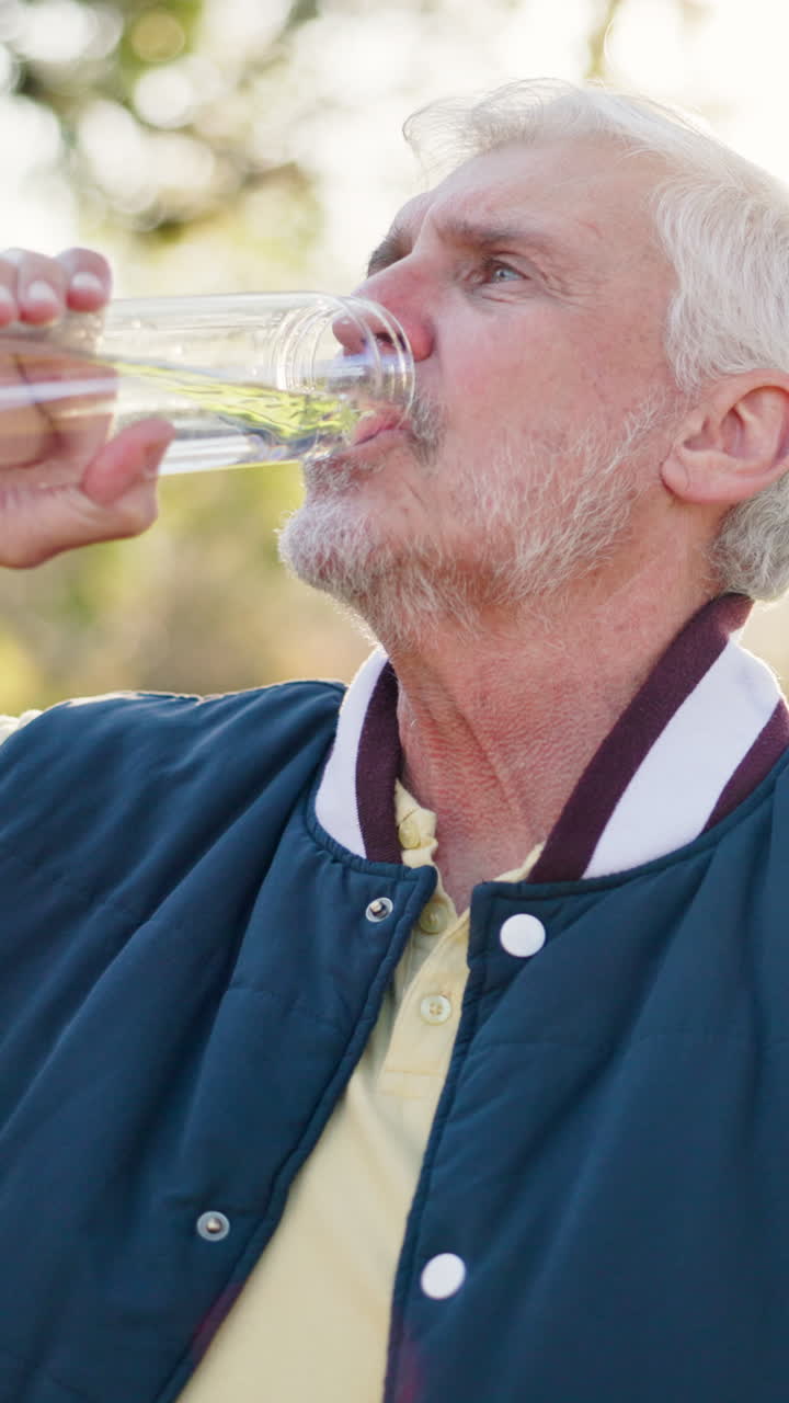 Senior Man Drinking Water from a Bottle Outdoors