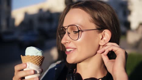 Side-View-Footage-Of-A-Attractive-Girl-Eating-Big-White-Ice-Cream-Outside-On-The-Street