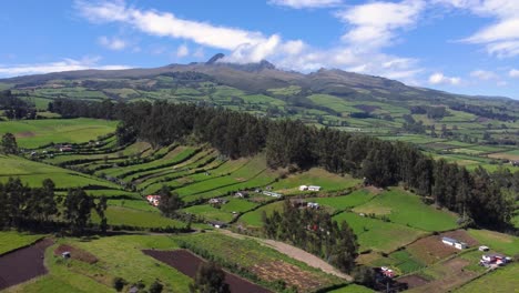 Aerial-drone-flight-over-the-green-province-of-Pichincha,-Ecuador,-guitig-naighborhood-on-the-slopes-of-the-ruminahui-volcan