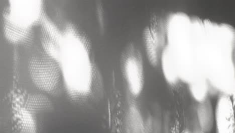 Light and shadow interplay on a gray background, creating a beautiful abstract texture with intricate patterns and soft gradients, perfect for design projects