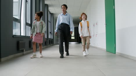 Teacher-and-pupils-walking-through-the-corridor.