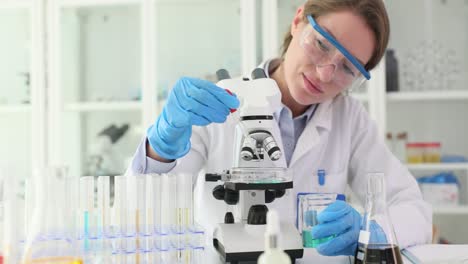 a female scientist conducting research with a microscope in a laboratory