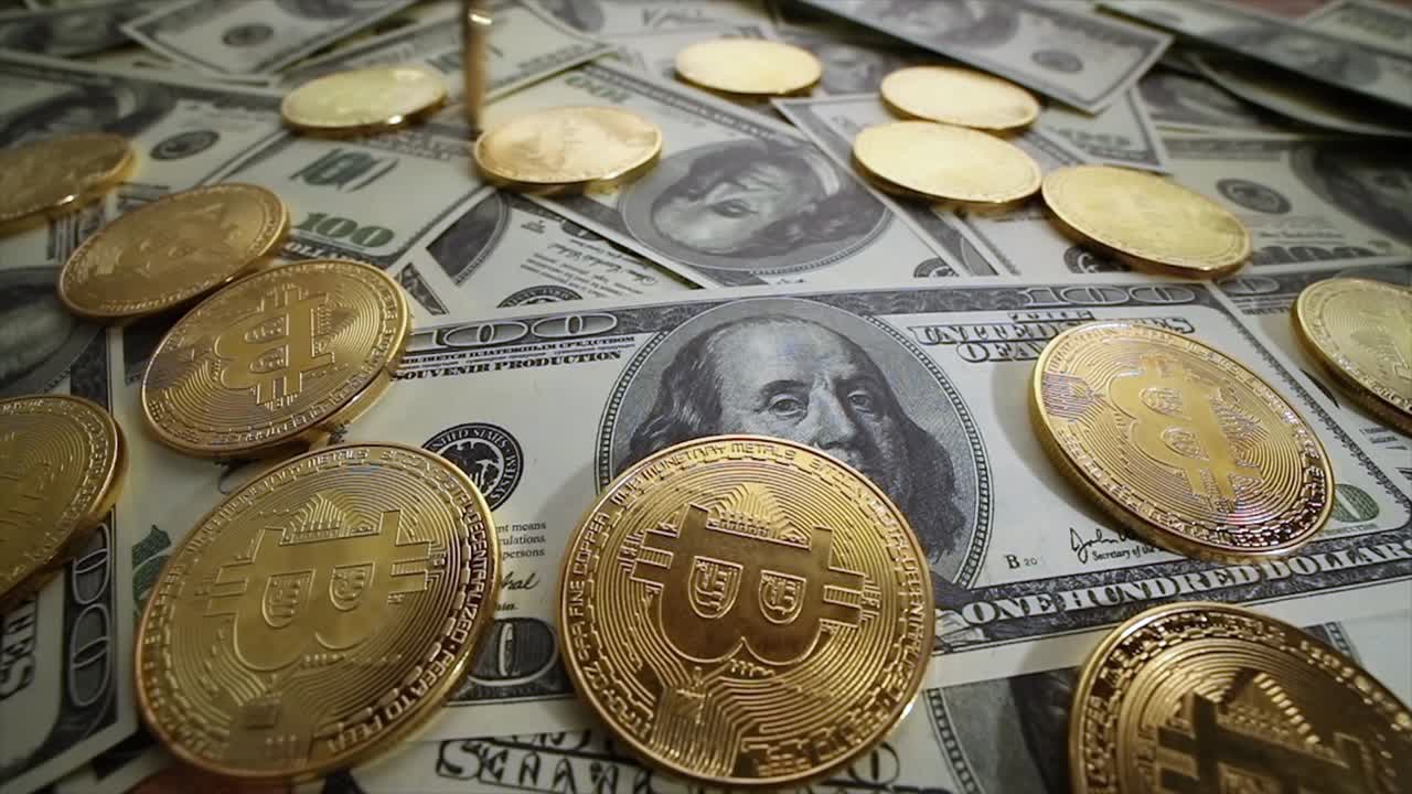 Gold Bit Coin BTC coins and dollar bills.