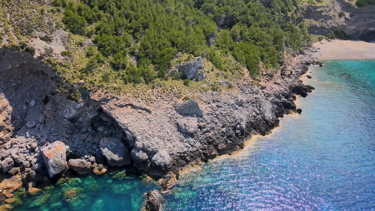 Witness stunning cliffs and clear waters at Coll Baix near Puerto de Alcudia, Mallorca. Experience the natural beauty and tranquility of this hidden gem in Mal Pas, perfect for relaxation.