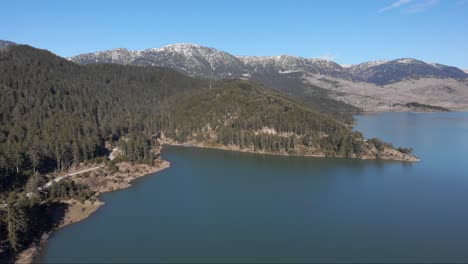 ascending drone view of aoos spring lake flying high altitude greece