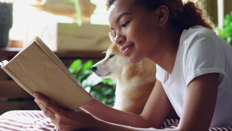 girl reading a book with a dog