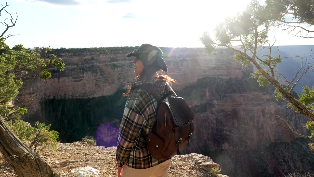 Happy Woman Hiker with Backpack Enjoying Grand Canyon View