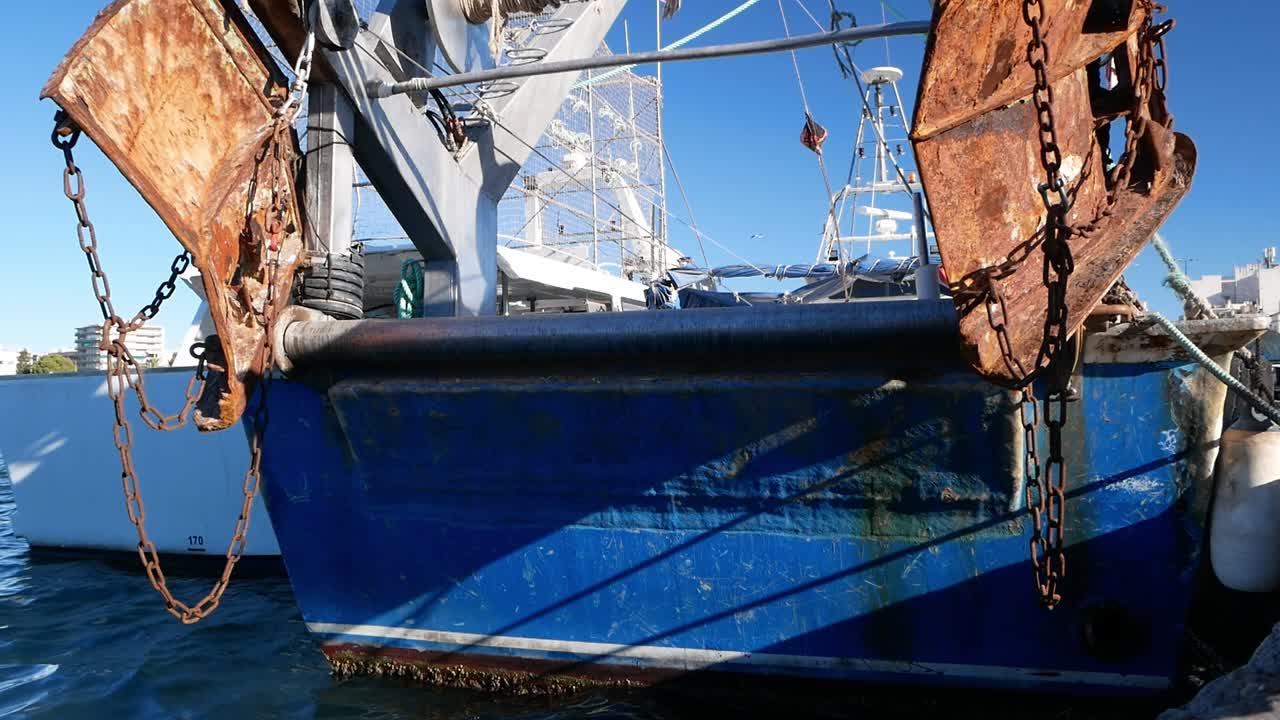 Shadow of a person passing over a fishing boat