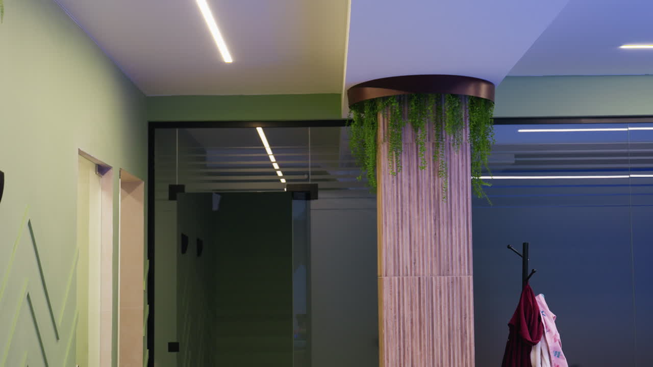 Camera capturing amazing eye catching interior decoration of house, bright light through glass windows, yellow lounge chair, framed paintings on walls, clean modern lines, cozy mood, neat arrangement