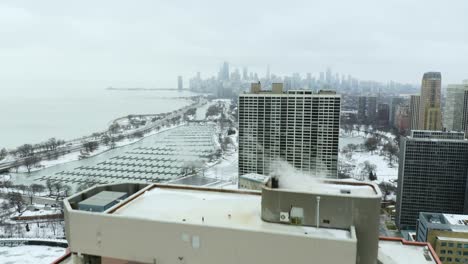 aerial reveal of chicago skyline during cold winter day