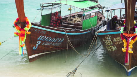 barcos de cola larga vacíos en las playas mientras llueve, tailandia