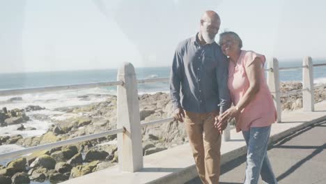 Happy-senior-african-american-couple-spending-time-together-at-the-seaside,-slow-motion