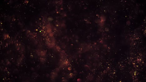 abstract dark background with chaotical motion of glimmering green-gold bubbles. balls rotation, abstract molecular brownian motion.