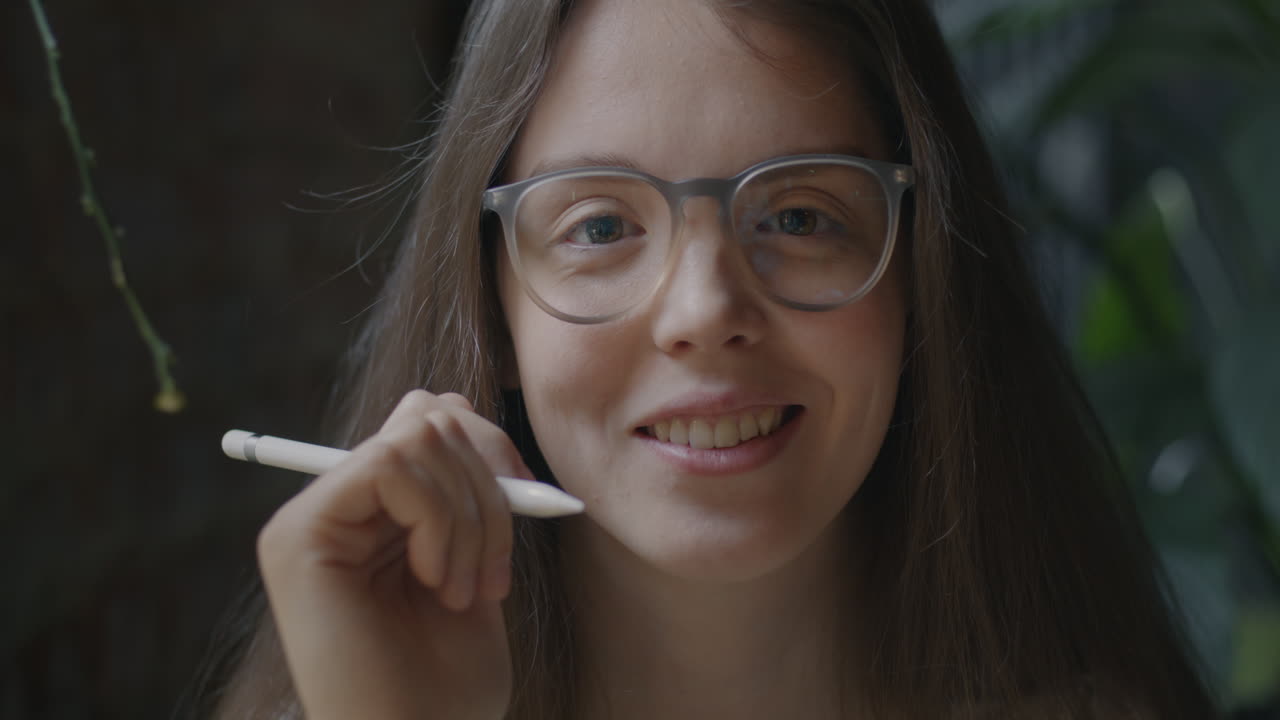 Smiling Woman Using a Digital Pen