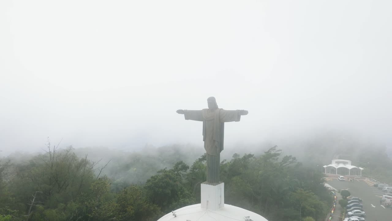 Aerial orbit of Cristo Redentor statue with fog rolling over, Puerto Plata, Dominican Republic
