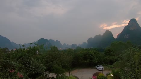 time lapse clip of a sunset over the beautiful green, lush and dense karst mountain landscape in yangshuo, guangxi province, china