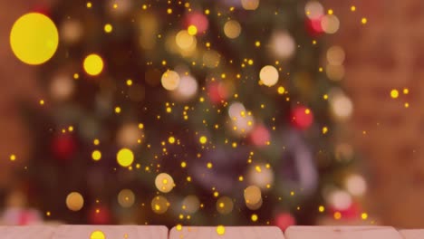 Animation-of-christmas-golden-dots-over-blurred-christmas-tree-in-background