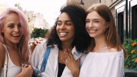 three friends laughing on the street