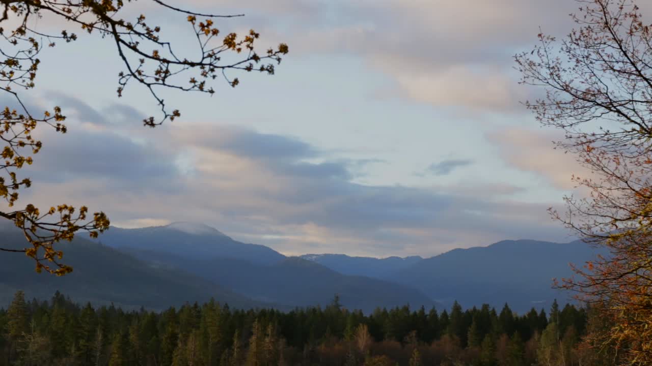 Incredible early morning sunrise time lapse over the mountains and trees with two directional cloud movement