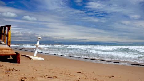 View-of-sea-coastline-damaged-in-Los-arenales-del-sol,-near-Alicante-city,-Spain-after-a-storm-with-the-view-of-mountain-range-in-a-distance