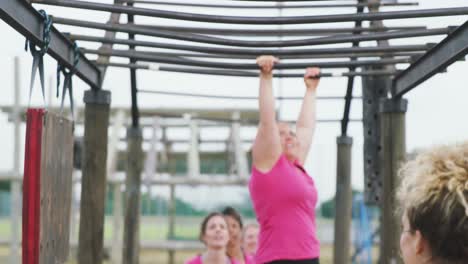 Caucasian woman exercising at bootcamp
