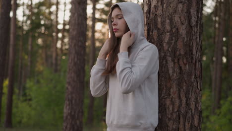 young woman standing in a forest