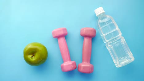 healthy lifestyle with fruits, dumbbells, and water