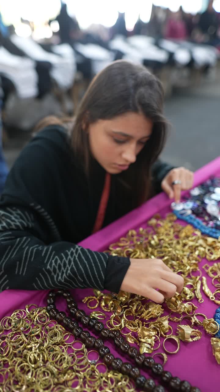 Woman Browsing Jewelry at a Market