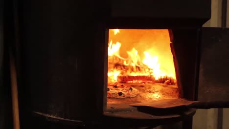 wood is burning in a pizza oven