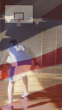 american flag waving against african american male basketball player practicing basketball