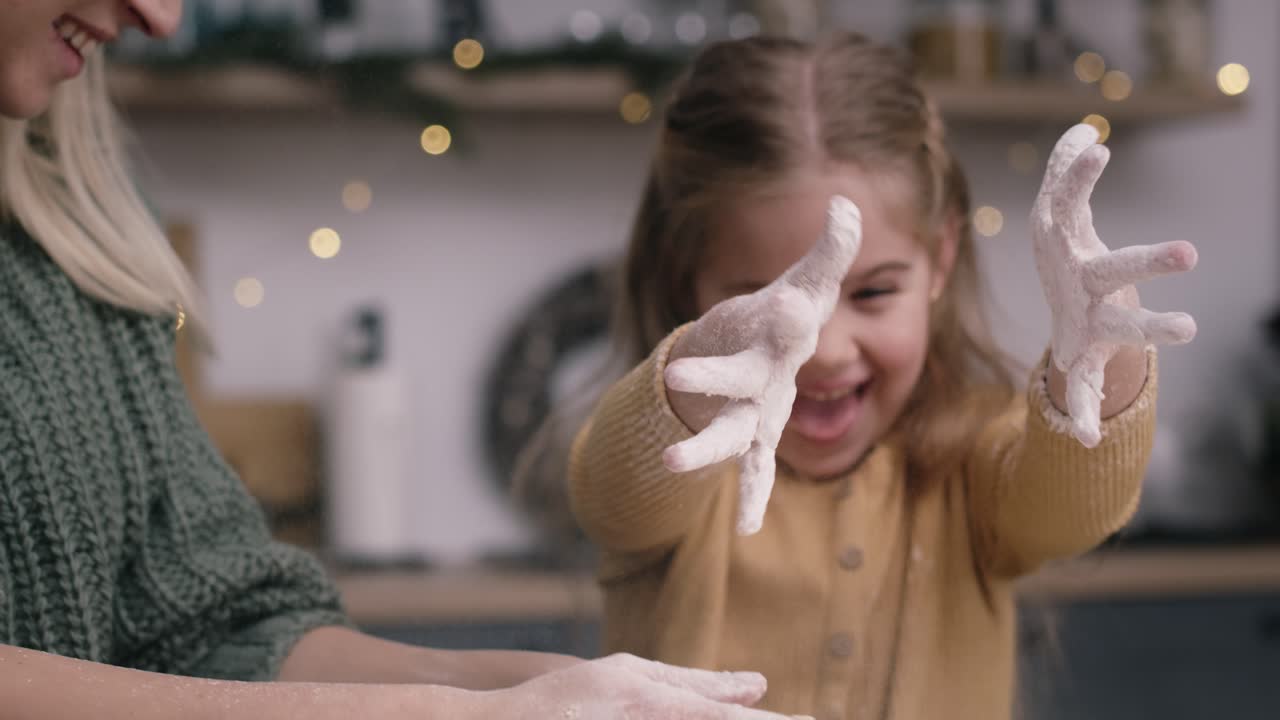 Handheld video of mother and daughter baking