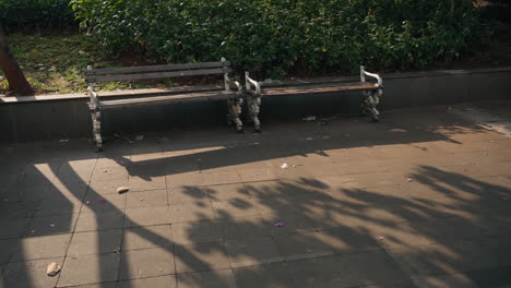 No-people-nobody-wooden-chair-at-city-park-abandoned-old-from-side