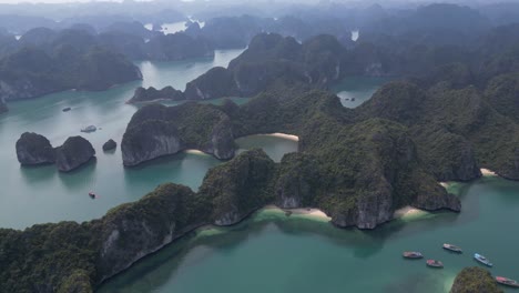 drone shot flying over cliffs and islands with blue water in cat ba and halong bay in northern vietnam