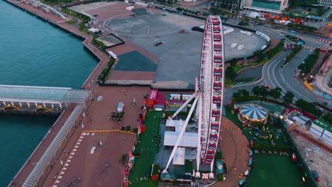 aerial view of observation wheel at downtown, hong kong during evening.
