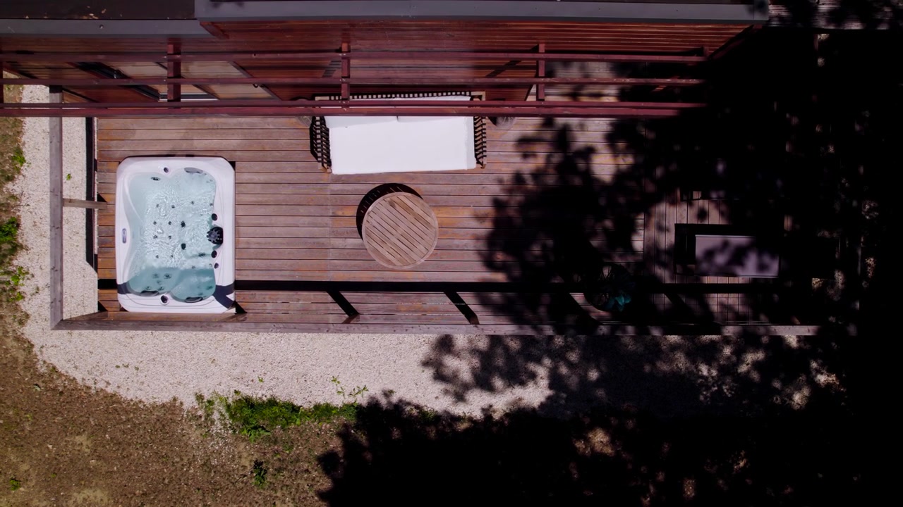 Aerial dolly shot overhead a hot tub on a villa balcony in Uzes