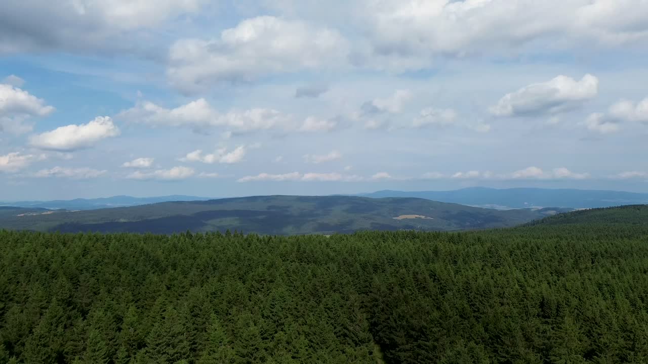 timelapse while camera is going up over the mountains with a view of other mountains and valleys on the horizon