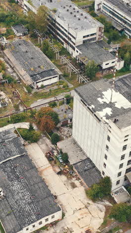 aerial view of industrial destroyed city buildings. view from above of ruined and abandoned factory. vertical video