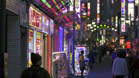 flashing neon signs on japanese street at night