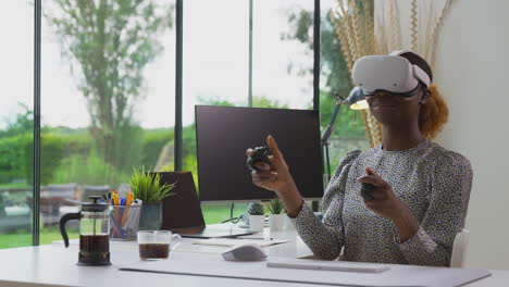 woman working from home office with controllers wearing vr headset interacting with ar technology