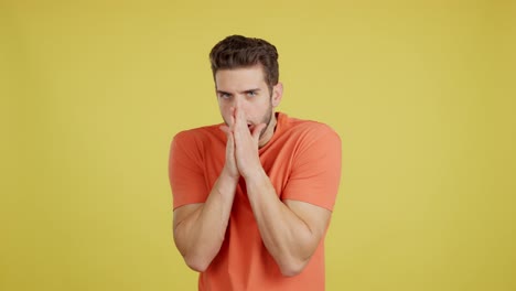 young man expressing various emotions on yellow background
